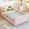 A pink upholstered bed with a built-in headboard shelf containing LED lighting and decorative items. Náhľad obrázku produktu
