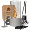 A tabletop fireplace with its accessories and packaging, displayed on a white background. Produktbild-Vorschau