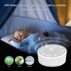 A baby sleeping in a crib with a sound machine nearby. Produktbild-Vorschau