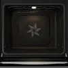 The interior of a black oven with a fan in the center and a light at the top. Produktbild-Vorschau
