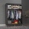 A portable wardrobe with clothes hanging inside and items stored on shelves and the floor. Anteprima dell’immagine prodotto