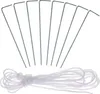 A set of tent stakes and a coil of rope on a white background. Produktbild-Vorschau