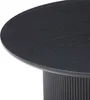 A close-up view of a round coffee table with a dark oak top and a fluted base. Voir les images du produit