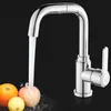 A chrome kitchen faucet with water running into a sink with fruit. Produktbild-Vorschau
