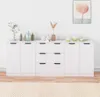 A white sideboard with various decorative items on top, against a white wall. Anteprima dell’immagine prodotto
