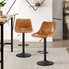 Two brown leather bar stools with black bases are shown in a dining or kitchen area. Produktbild-Vorschau