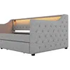 A close-up, side view of a grey upholstered daybed with built-in LED lighting. Produktbild-Vorschau