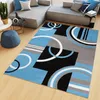 A modern living room with a sectional sofa and a rug. Voir les images du produit
