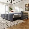 A modern bedroom with a pull-out sofa bed, a chandelier, and decorative wall art. Produktbild-Vorschau