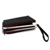 A black clutch bag with red lining, holding two smartphones, with a wrist strap attached. Produktbild-Vorschau