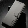 A gray flip phone case is shown on a dark, textured surface. Produktbild-Vorschau