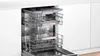 An open dishwasher with two racks pulled out. Produktbild-Vorschau