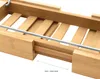 Close-up of a wooden bathtub tray with a metal bar, showing its adjustable length. Produktbild-Vorschau