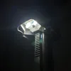 A close-up, low-angle shot of the top of a drill press, focusing on the chuck and the laser guide. Produktbild-Vorschau
