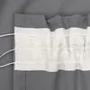 A close-up view of a gray curtain with a white header tape and gathering strings. Náhled obrázku produktu