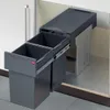 A pull-out trash bin system with two compartments inside a cabinet. Voir les images du produit