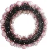 A circular wreath decorated with pink baubles and rose gold tinsel. Voir les images du produit
