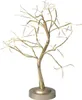 A decorative LED tree with a gold-colored trunk and branches, illuminated by warm white lights, standing on a circular base. Anteprima dell’immagine prodotto