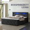 A bedroom setting featuring a black boxspring bed with blue LED lighting. Produktbild-Vorschau