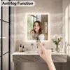 A bathroom vanity with a lighted mirror, a sink, and toiletries. Náhľad obrázku produktu
