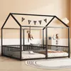 A black metal house-shaped bed frame with two mattresses, a hanging monkey toy, and decorative flags. Podgląd zdjęcia produktu