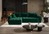 A luxurious living room with a large green sectional sofa, fireplace, and coffee tables. Náhled obrázku produktu