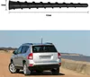 A black antenna shown above a silver car. Produktbild-Vorschau