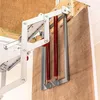 Close-up view of the mechanism of a folding attic ladder, showing springs and metal components. Produktbild-Vorschau