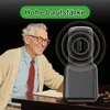 An elderly man is smiling while looking at a device that is emitting sound waves. Produktbild-Vorschau