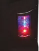 A close-up of a black speaker with a red and blue light. Voir les images du produit