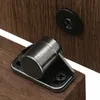 A close-up view of two magnetic door catches mounted on wooden surfaces. Produktbild-Vorschau