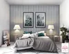 A bedroom scene with a bed, lamps, and artwork on the wall. Produktbild-Vorschau