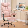 A pink ergonomic office chair is shown in a home office setting with a desk and computer. Podgląd zdjęcia produktu