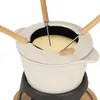 A close-up view of a fondue set with cheese inside. Voir les images du produit
