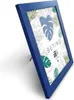 A blue picture frame with a tropical leaf pattern inside, standing on a white surface. Náhľad obrázku produktu