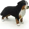 A miniature figurine of a Bernese Mountain Dog standing on a white surface. Produktbild-Vorschau