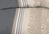 Close-up view of bedding with a striped border and ornamental pattern. Produktbild-Vorschau