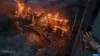 A city engulfed in flames, viewed from a high vantage point with a gloved hand reaching out in the foreground. Produktbild-Vorschau