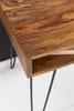 A close-up view of a wooden desk with black metal legs. Produktbild-Vorschau