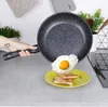 A hand holding a frying pan over a plate with toast and a fried egg. Náhled obrázku produktu