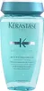 A bottle of Kerastase shampoo against a light blue background. Podgląd zdjęcia produktu