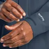A close-up shot of a person's hands adjusting the cuff of a dark blue jacket. The jacket has the "TEXAPORE" logo printed on the sleeve. Anteprima dell’immagine prodotto