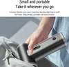 A hand is placing a portable dust blower into a bag. Náhled obrázku produktu