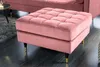 A pink velvet ottoman with gold and black legs on a dark floor. Produktbild-Vorschau