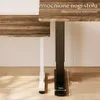 Close-up of two desk legs, one white and one black, with a wooden desk surface. Text overlays provide product information. Podgląd zdjęcia produktu