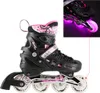A pair of pink and black inline skates with LED lights on the wheels. Produktbild-Vorschau