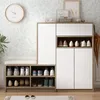 A shoe cabinet with a bench on top, placed against a floral wallpaper. Produktbild-Vorschau