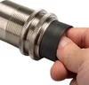 A hand is shown adjusting a black rubber sleeve on a metal threaded connector. Produktbild-Vorschau