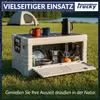 Beige Plastikkiste mit Trucky Logo, offen auf einer Wiese mit Campinggeschirr gefüllt Produktbild-Vorschau