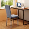 A gray velvet chair is placed next to a wooden desk with a laptop and books. Náhľad obrázku produktu